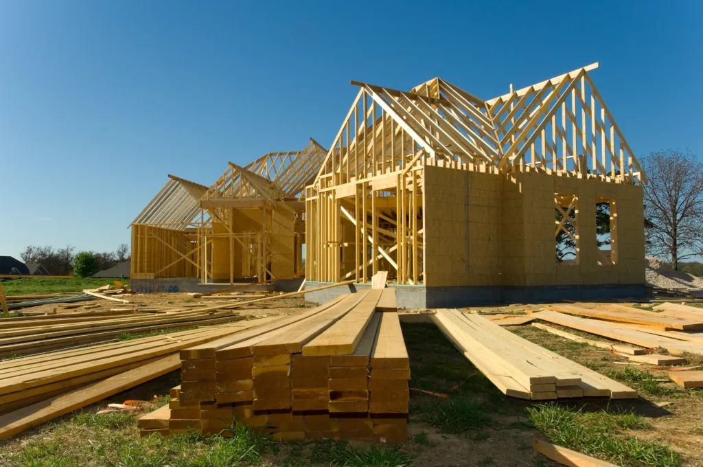 New home under construction with wood, trusses and supplies.