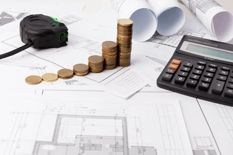 Stacks of coins, a tape measure, and a calculator placed on architectural plans — How to Manage Rising Costs in the Construction Industry cover
