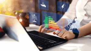 A person analyzes energy efficiency and sustainability data on a laptop interface — Enhancing Construction Efficiency Key Factors and Strategies article