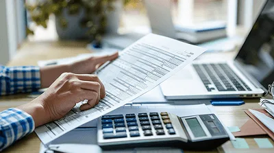 A contractor reviews a document at a desk — Construction Change Order FAQ Clarity and Insigths article