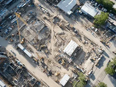 Construction Purchase Order Process 2 An aerial view of a large construction site with cranes, machinery, and active excavation areas — Construction Purchase Order Process article