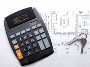 A calculator and house keys resting on architectural plans — Understanding Direct and Indirect Costs in Construction Projects article