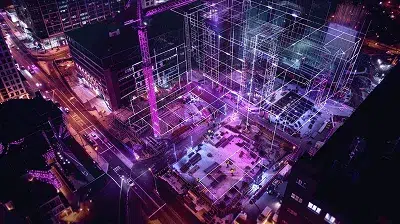 Aerial night view of a construction site with glowing purple digital wireframes visualizing data flow and system integration across buildings — how synced ERP and accounting software data can unlock real-time construction cost control article